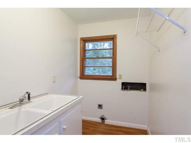 11709 Strickland Road Raleigh, NC 27613 - Photo 10 of 25 a bathroom with a sink and a window