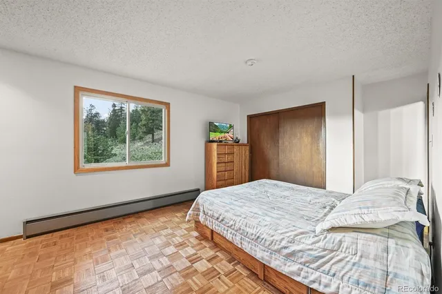 a bedroom with a bed and a desk