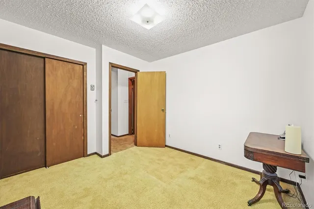 a bed room with a bed and a window