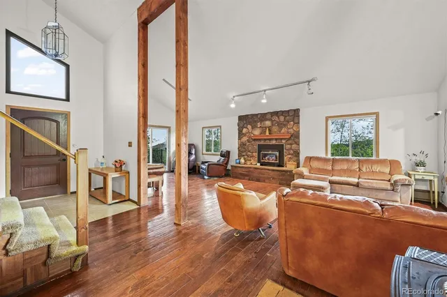 a living room with furniture a window and a fireplace