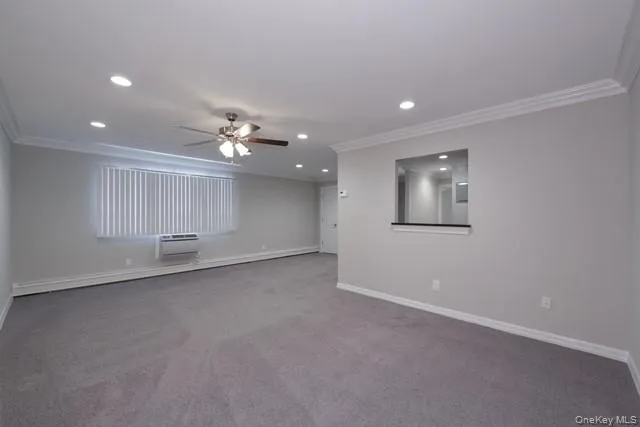 an empty room with a empty space and a ceiling fan