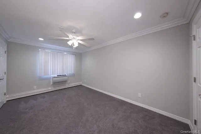 an empty room with a ceiling fan and window