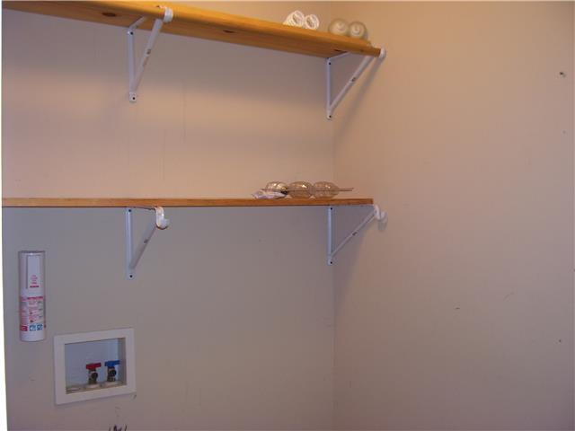 1075 Cliff White Road Columbia, TN 38401 - Photo 13 of 20 Laundry room off back of kitchen has shelving and hook up for electric dryer.