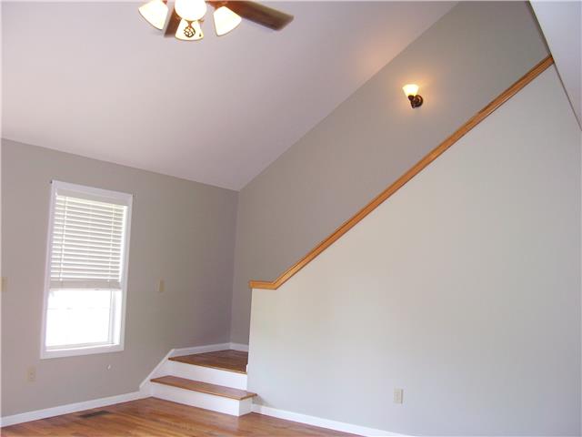 1075 Cliff White Road Columbia, TN 38401 - Photo 6 of 20 Partially enclosed finished wood stairway leads to upstairs loft area, great for office or sitting area. This home has dual units with separate thermostats!