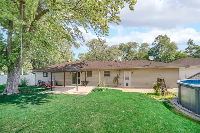 a front view of house with yard and outdoor seating