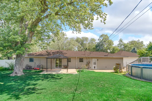 a front view of a house with a garden and yard