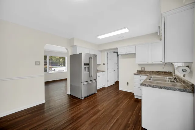 a kitchen with stainless steel appliances a refrigerator and a stove top oven