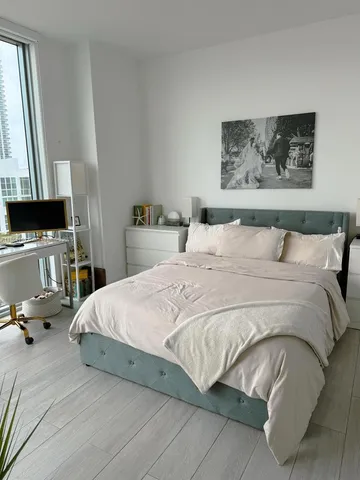 a bedroom with a bed and dresser