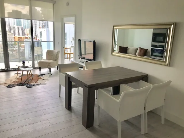 a dining room with furniture and window