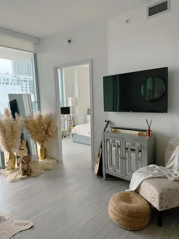 a bedroom with furniture and a flat screen tv