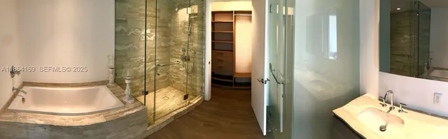 a bathroom with a tub and shower