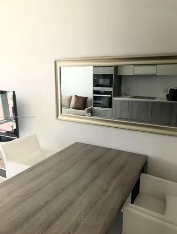 a living room with a bed furniture and a window