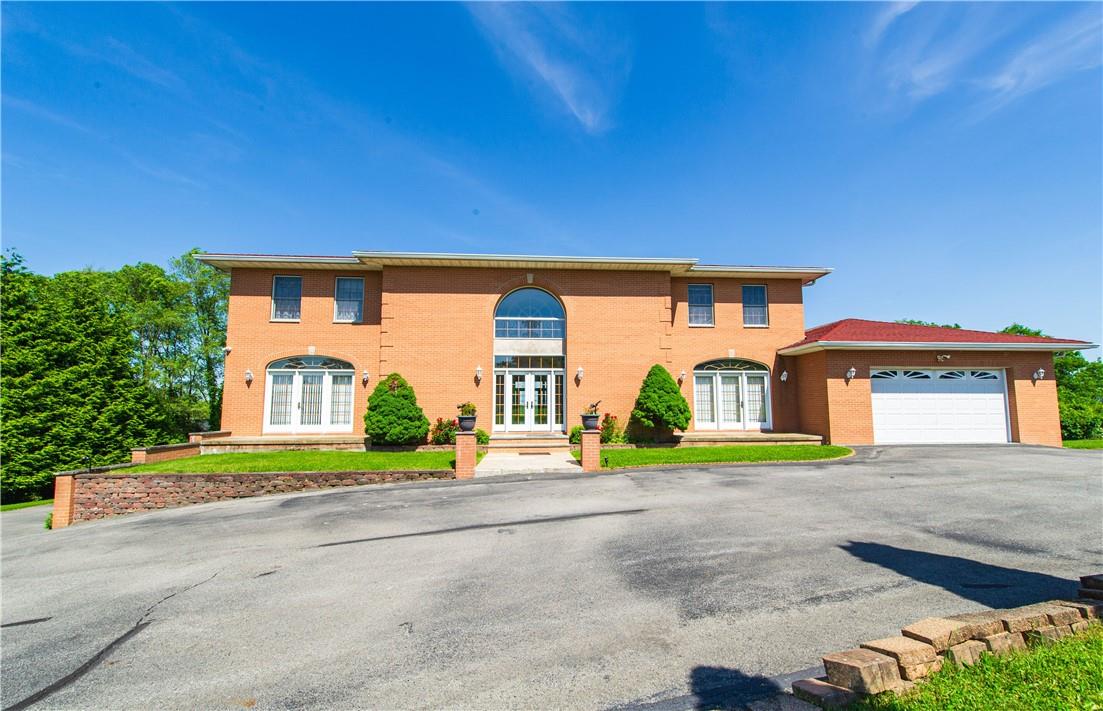 a front view of a house with a yard and a garage