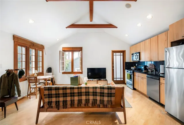 a kitchen with stainless steel appliances kitchen island granite countertop a refrigerator and a stove top oven