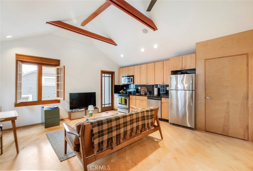 1447 Calumet Avenue, Unit B Los Angeles, CA 90026 - Photo 5 of 12 a kitchen with stainless steel appliances kitchen island granite countertop a refrigerator and a stove top oven