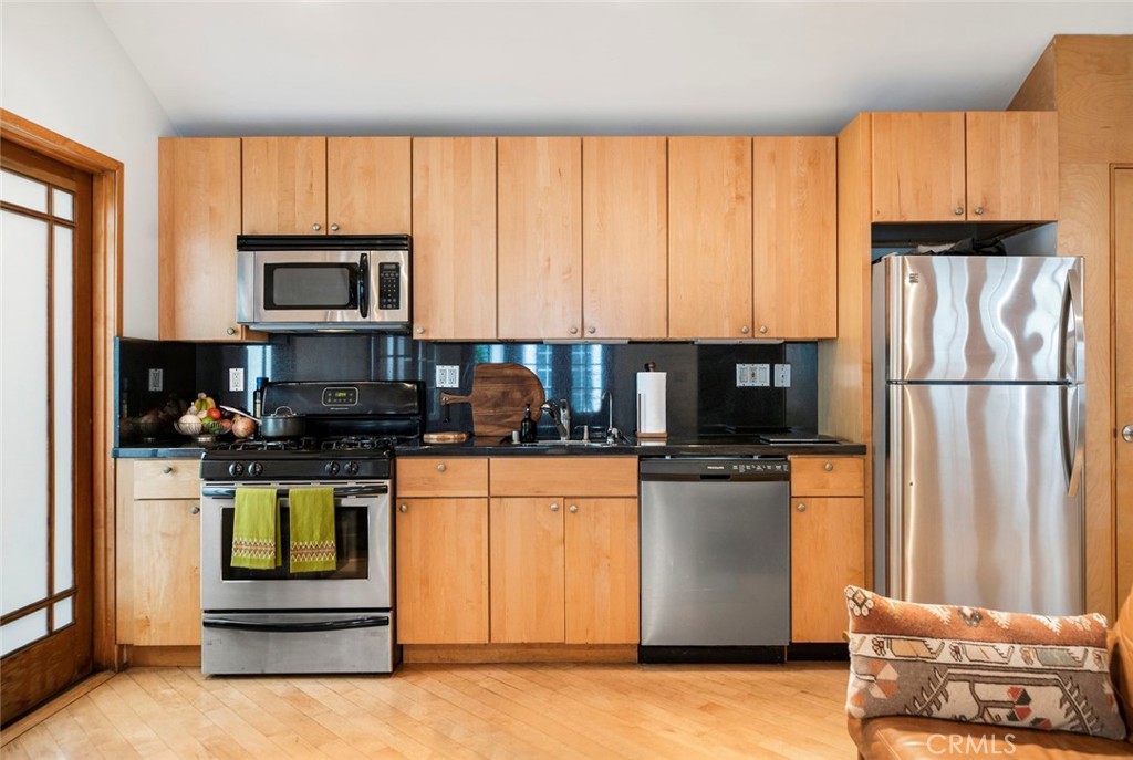 1447 Calumet Avenue, Unit B Los Angeles, CA 90026 - Photo 6 of 12 a kitchen with stainless steel appliances granite countertop a stove a refrigerator and a microwave