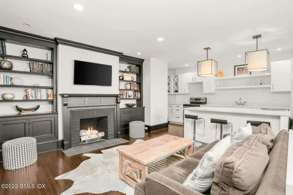 a living room with furniture fireplace and flat screen tv