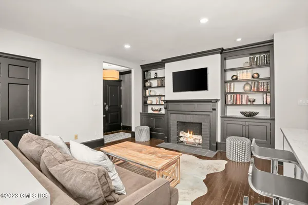 a living room with furniture fireplace and flat screen tv