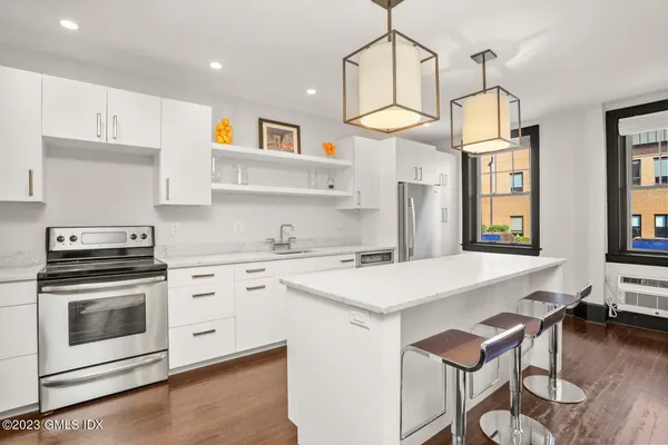 a kitchen with a stove a sink and a refrigerator