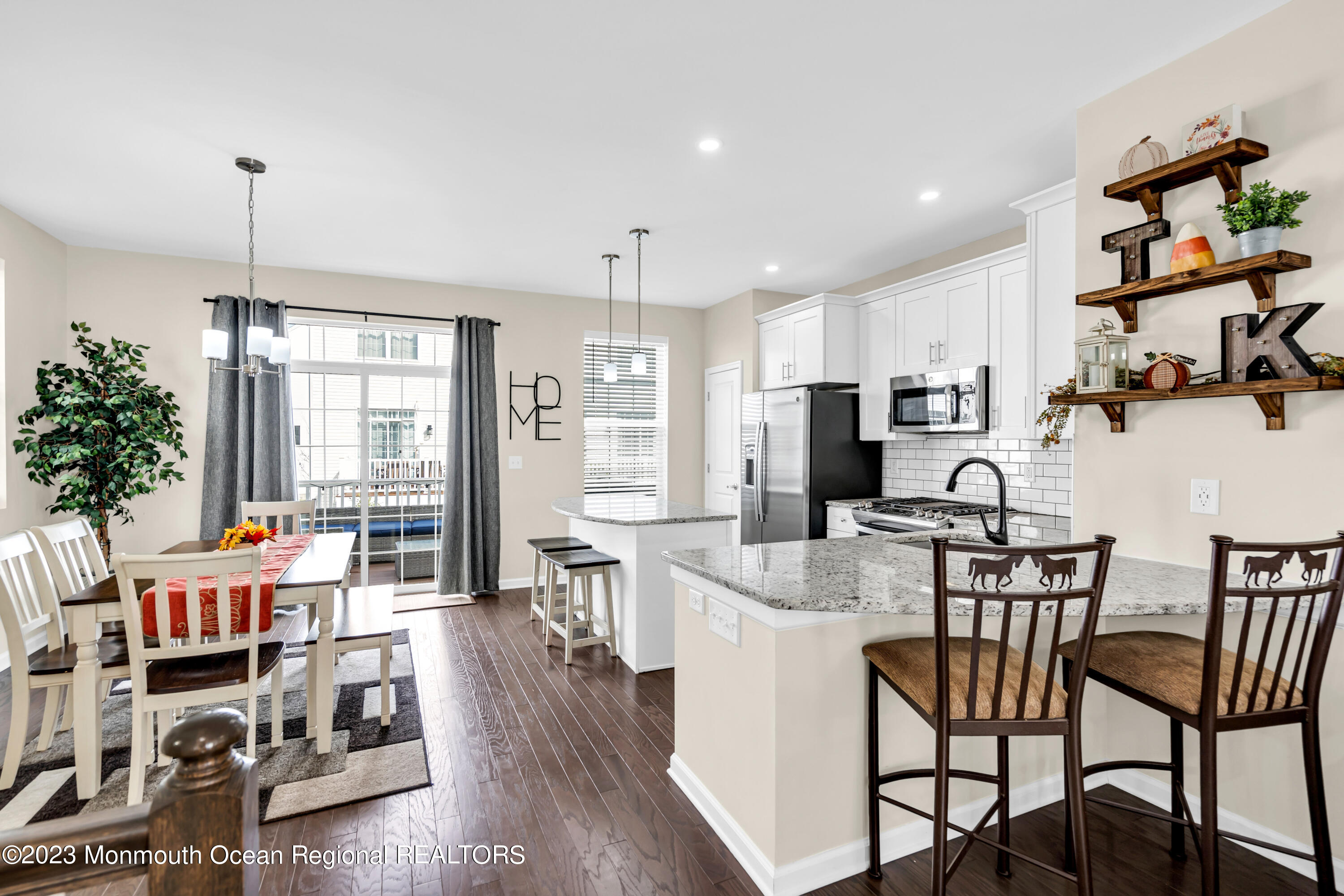 201 Revival Road Brick, NJ 08723 - Photo 12 of 41 a kitchen with stainless steel appliances kitchen island granite countertop a table chairs and a living room view