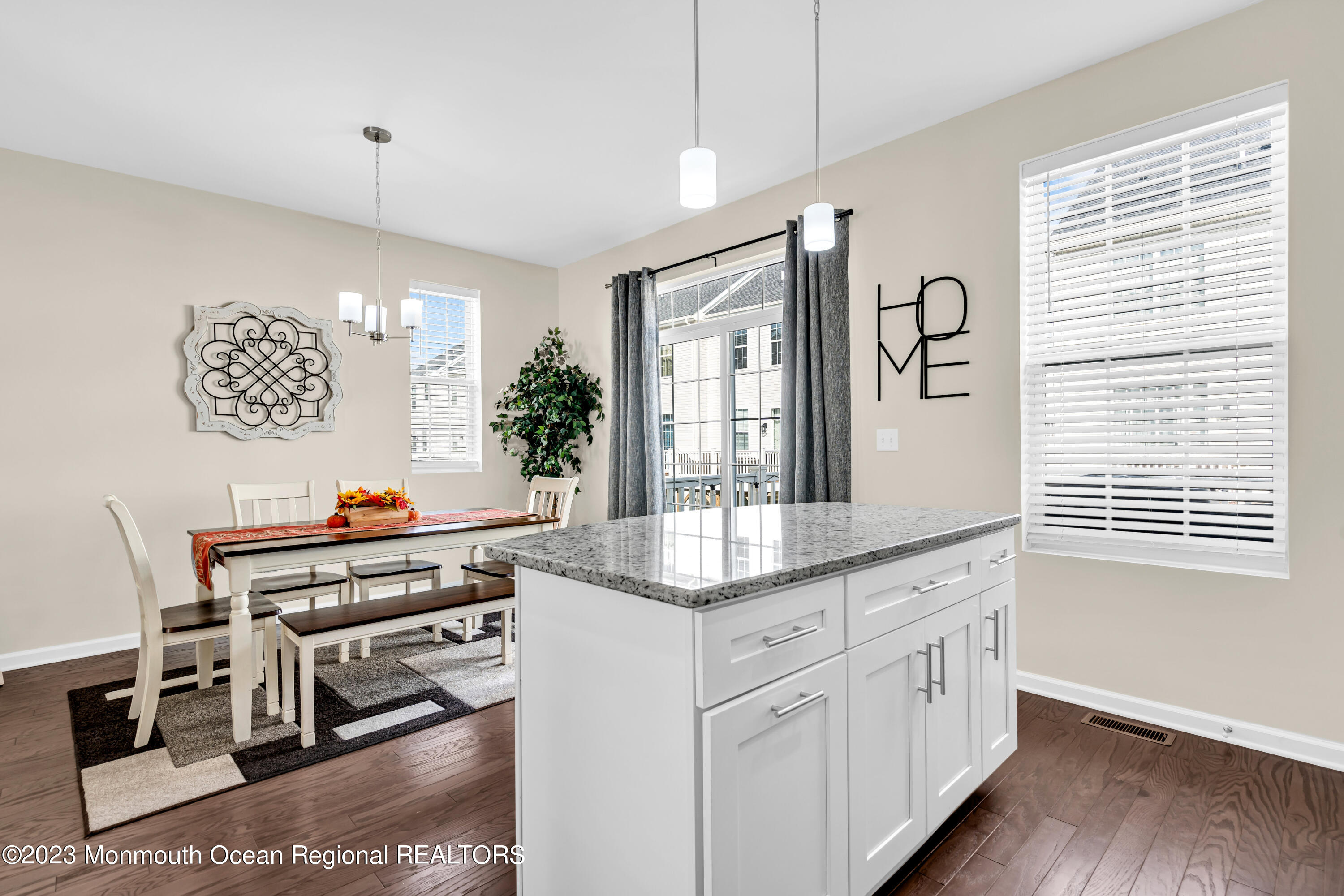 201 Revival Road Brick, NJ 08723 - Photo 17 of 41 a kitchen with stainless steel appliances kitchen island wooden floors and white cabinets