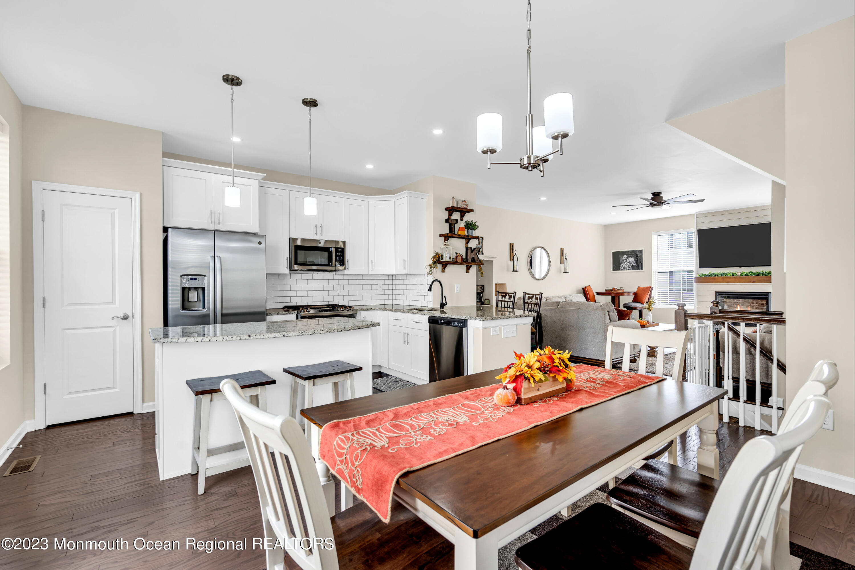 201 Revival Road Brick, NJ 08723 - Photo 21 of 41 a outdoor kitchen with stainless steel appliances kitchen island granite countertop a dining table chairs and refrigerator
