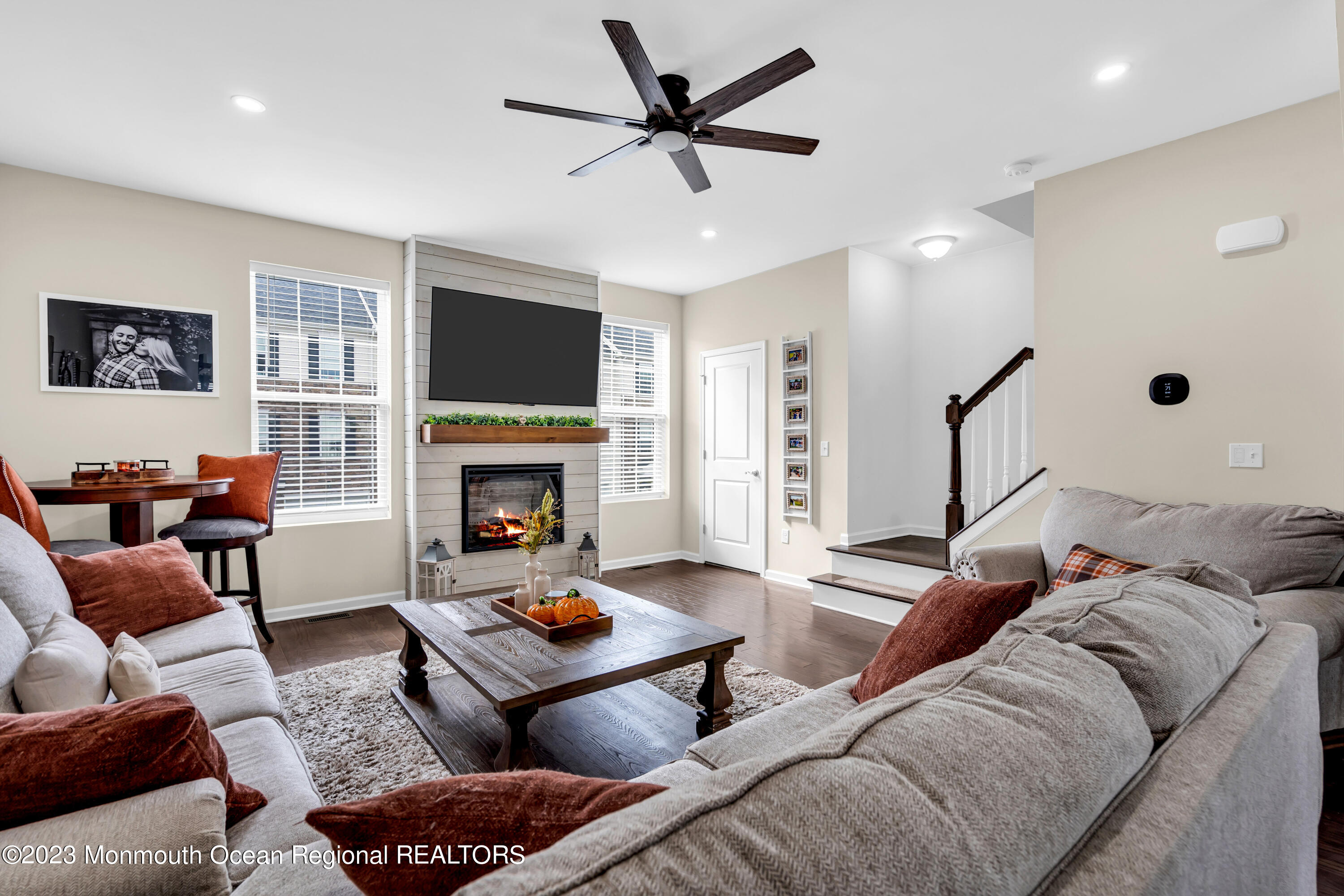 201 Revival Road Brick, NJ 08723 - Photo 23 of 41 a living room with furniture a flat screen tv and a fireplace