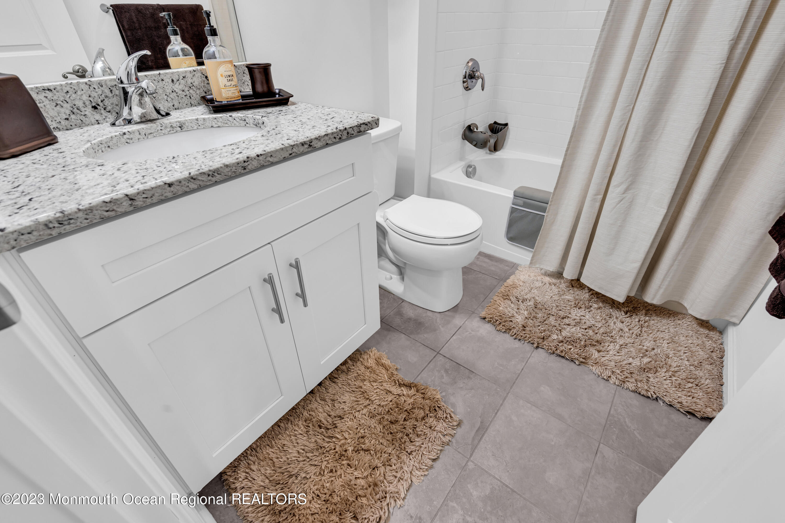 201 Revival Road Brick, NJ 08723 - Photo 35 of 41 a bathroom with a granite countertop sink a toilet and a vanity