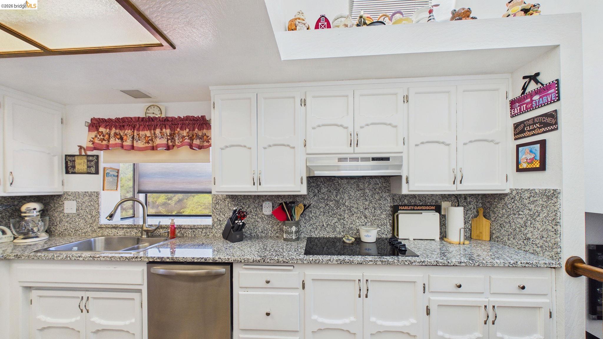 11858 Campo Seco Road Sonora, CA 95370 - Photo 15 of 45 Kitchen featuring white cabinetry, stone-finish countertops, a double basin stainless steel sink with a gooseneck faucet, and a built-in cooktop with an overhead range hood