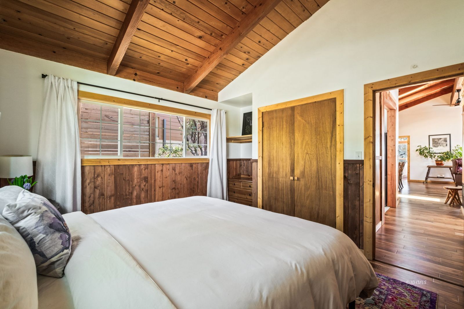 24750 Marion Ridge Drive Idyllwild, CA 92549 - Photo 27 of 45 a bedroom with a large bed and wooden floor