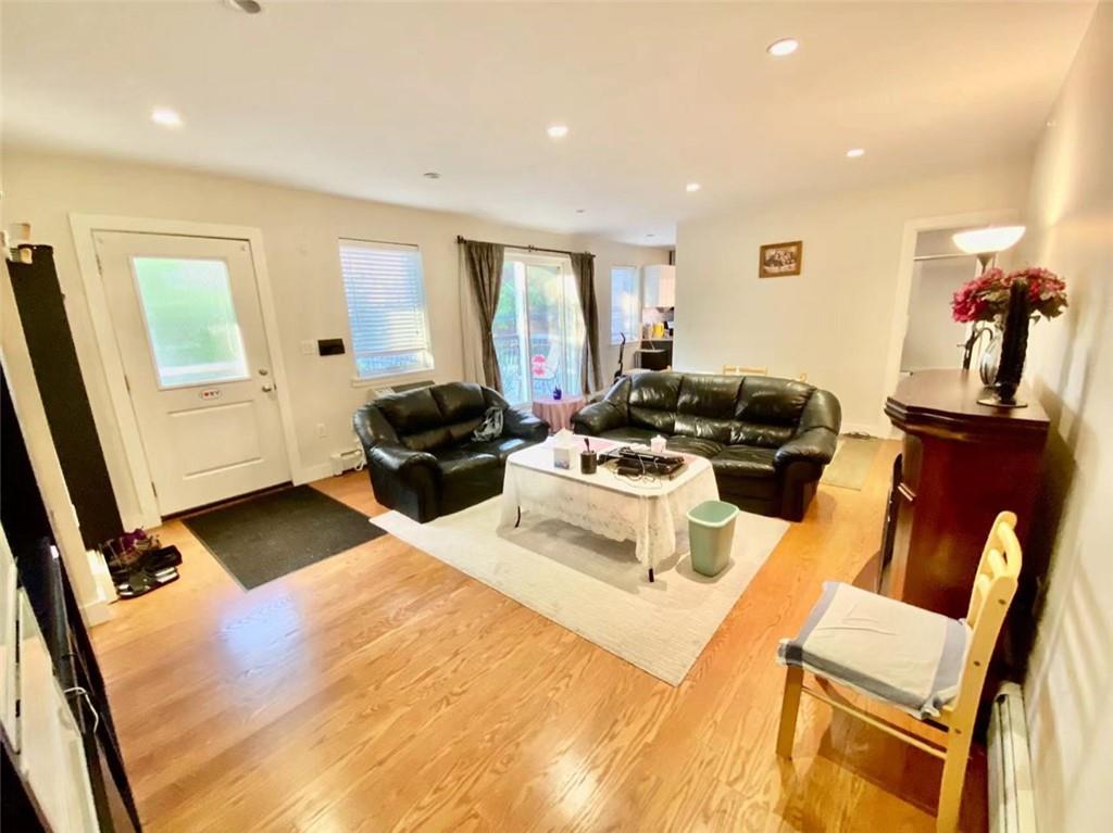 1244 Avenue X, Unit 2A Brooklyn, NY 11235 - Photo 11 of 14 a living room with furniture gym equipment and a window