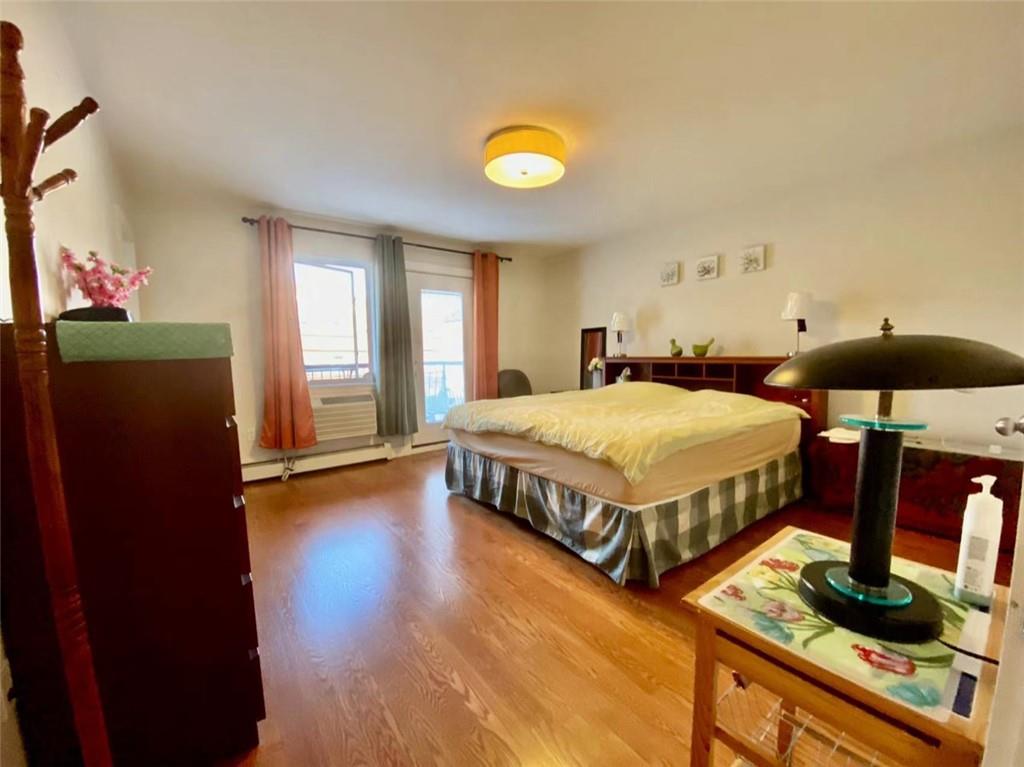 1244 Avenue X, Unit 2A Brooklyn, NY 11235 - Photo 3 of 14 a bedroom with a bed and wooden floor