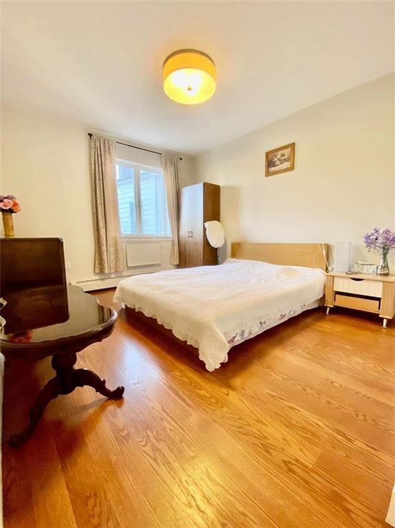 1244 Avenue X, Unit 2A Brooklyn, NY 11235 - Photo 5 of 14 a bedroom with a bed and a chair