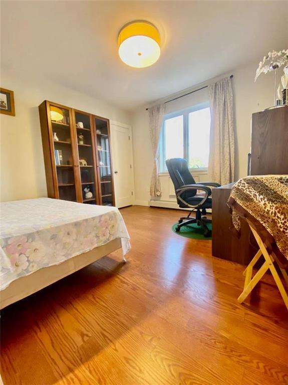 1244 Avenue X, Unit 2A Brooklyn, NY 11235 - Photo 6 of 14 a bed sitting in a room next to a window