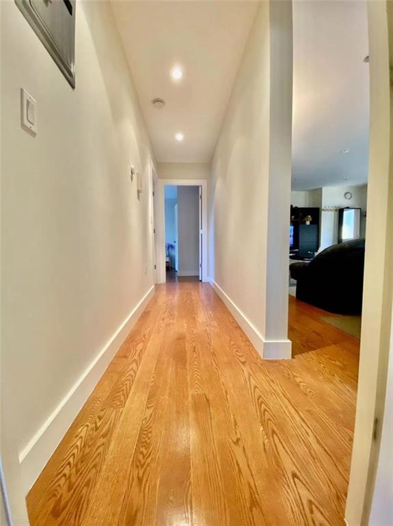 1244 Avenue X, Unit 2A Brooklyn, NY 11235 - Photo 8 of 14 a view of a big room with wooden floor and a bathroom