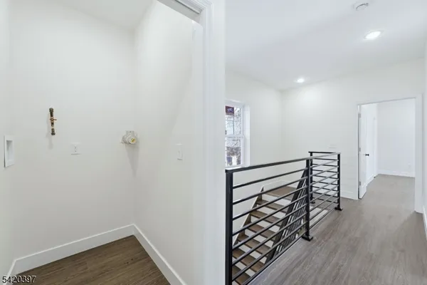 a view of hallway with wooden floor