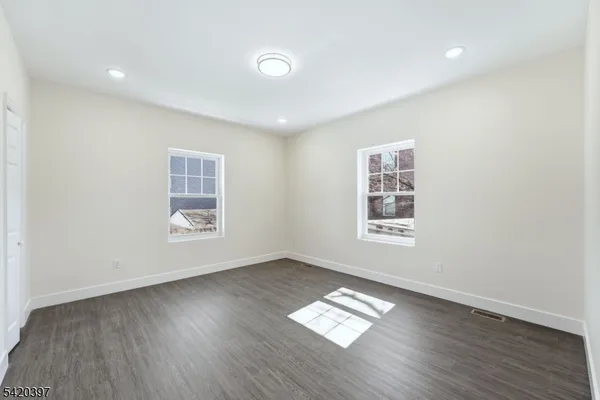 a view of wooden floor and windows in a room