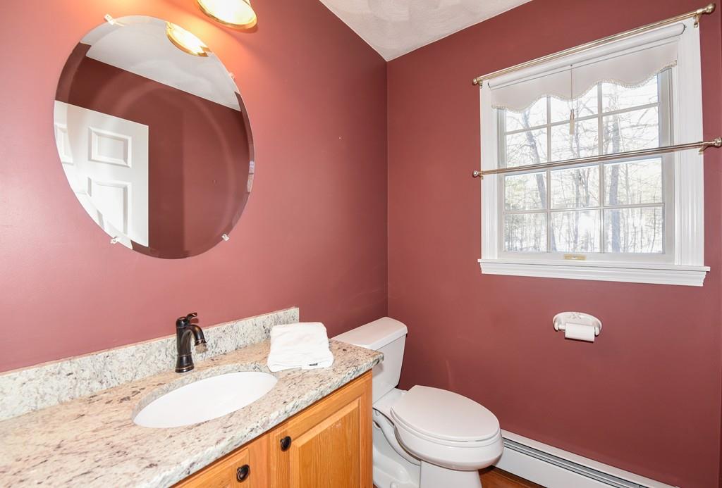 624 Boston Road Groton, MA 01450 - Photo 13 of 25 a bathroom with a granite countertop toilet sink and mirror