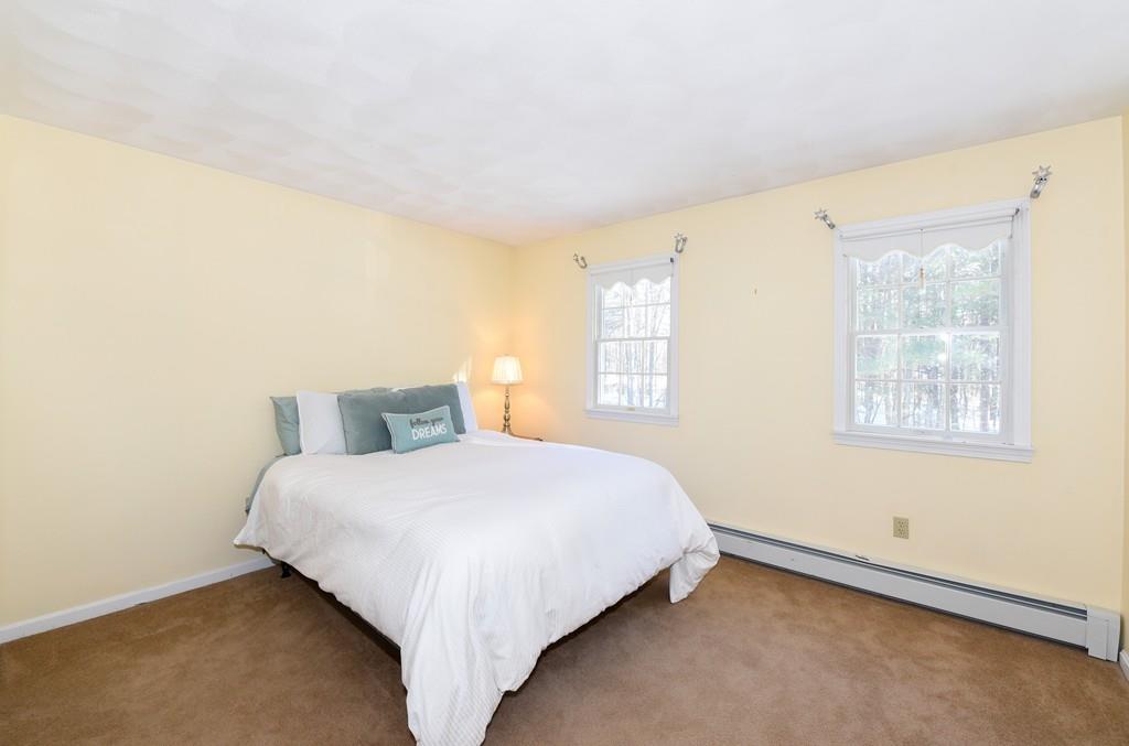 624 Boston Road Groton, MA 01450 - Photo 17 of 25 a bedroom with a bed and a window