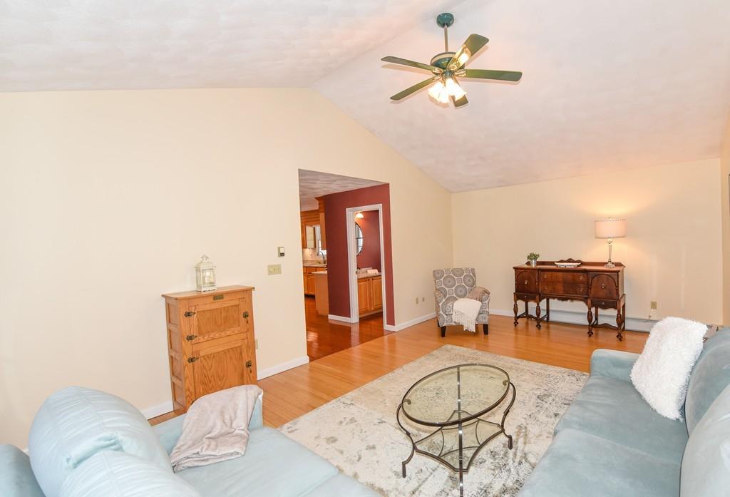 624 Boston Road Groton, MA 01450 - Photo 2 of 25 a living room with furniture and a chandelier