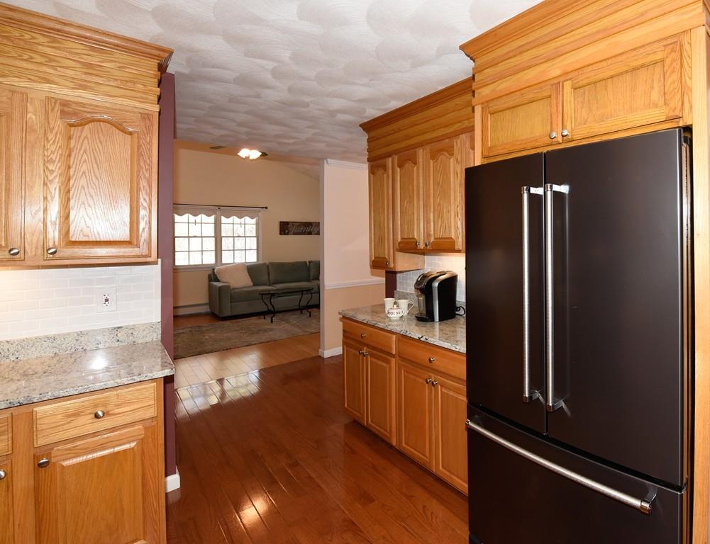 624 Boston Road Groton, MA 01450 - Photo 6 of 25 a kitchen with granite countertop a refrigerator and a sink
