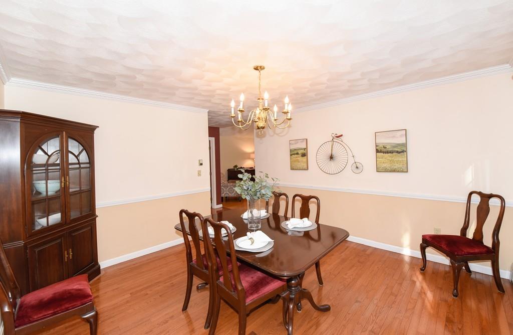 624 Boston Road Groton, MA 01450 - Photo 9 of 25 a view of a dining room with furniture and wooden floor
