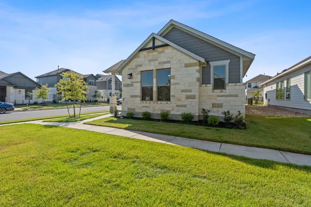 a front view of house with yard and green space