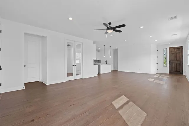 a view of an empty room with a ceiling fan