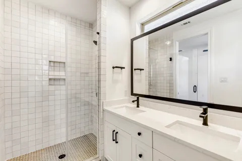an empty room with wooden floor cabinet and a ceiling fan