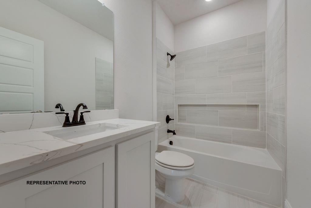 1032 Monaco Court Springtown, TX 76082 - Photo 16 of 18 a bathroom with a sink a toilet and shower