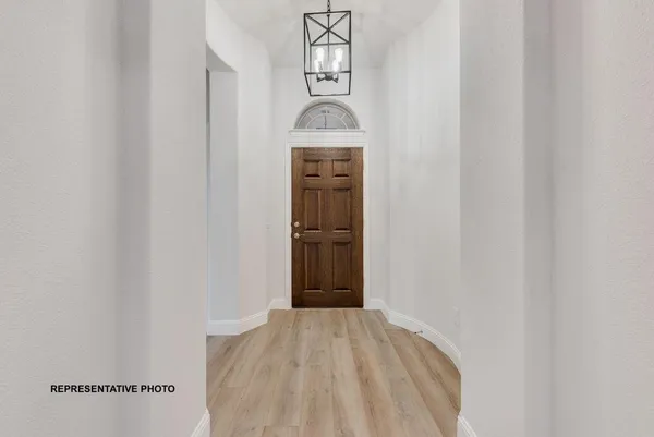 a view of a hallway to rooms