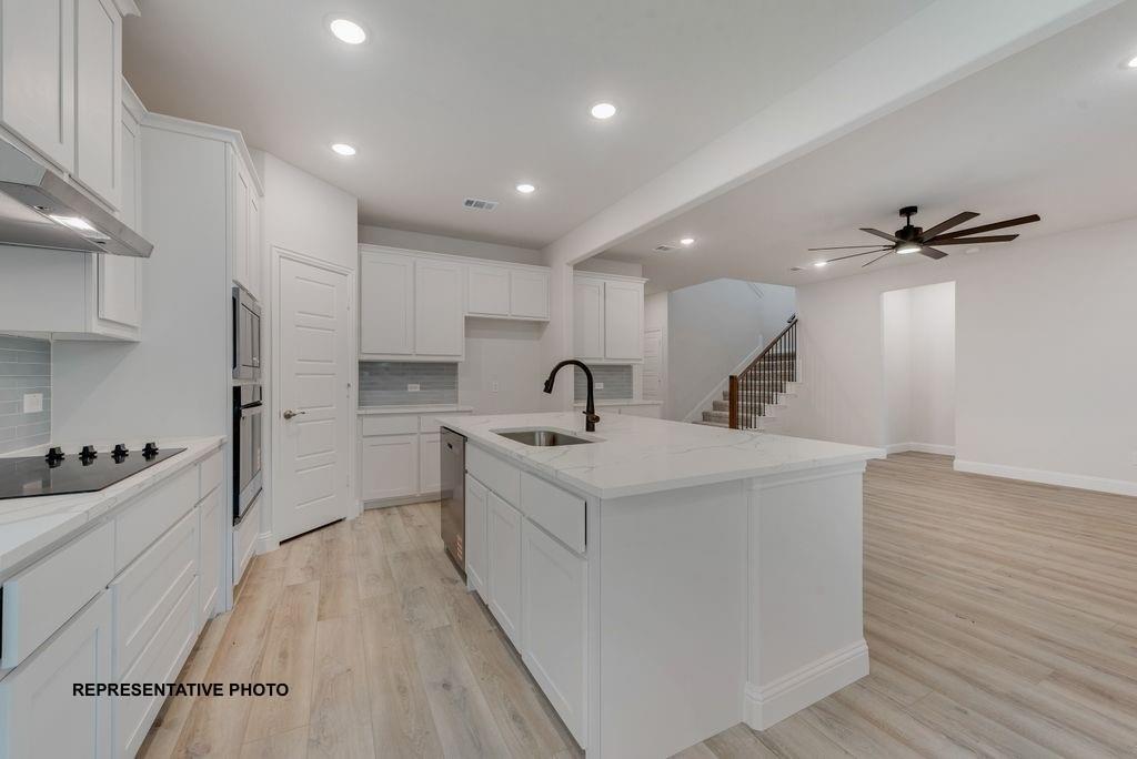 1032 Monaco Court Springtown, TX 76082 - Photo 5 of 18 a view of kitchen with sink refrigerator and wooden floor