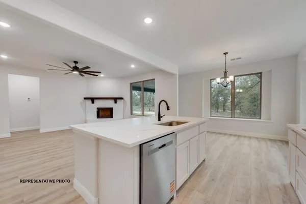 a view of kitchen with sink microwave and refrigerator