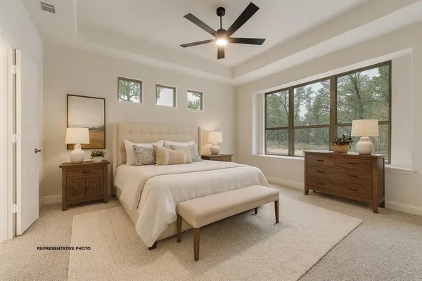 a bedroom with a bed and a large window